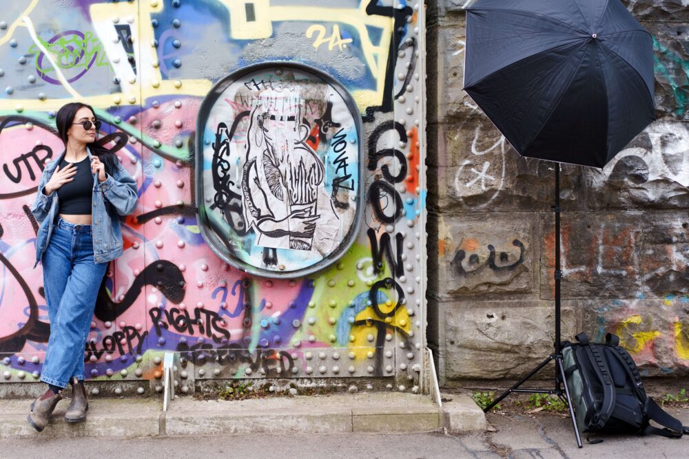 Brand photography portrait of Tash against a graffiti wall during an urban location shoot